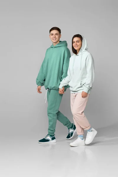 Young couple wearing mint green casual hoodie — Stock Photo, Image