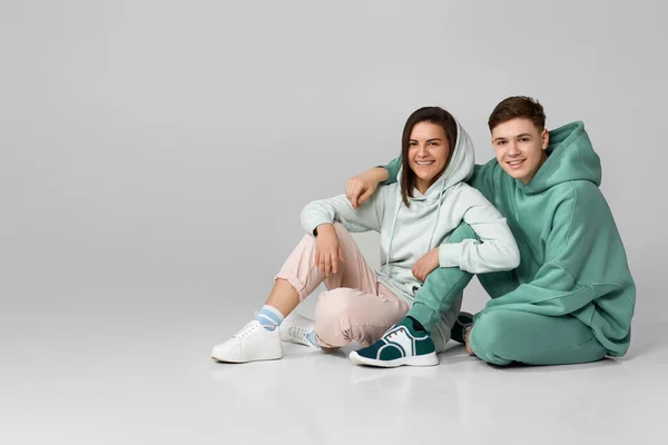 Young couple wearing mint green casual hoodie — Stock Photo, Image