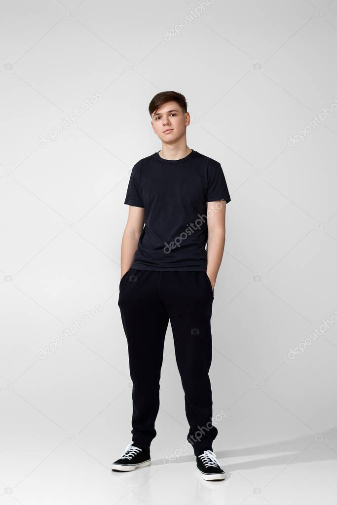 Handsome guy in black t-shirt looking into camera