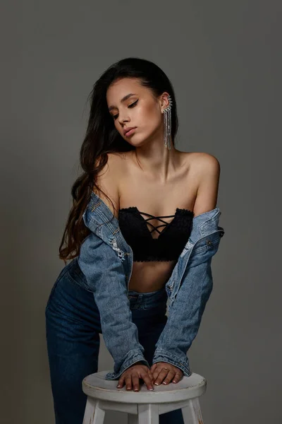 Mooie modieuze jonge vrouw in jeans poseren — Stockfoto