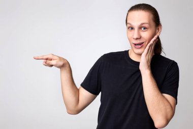 Siyah tişörtlü, şaşkın bir genç parmak uzatıyordu.