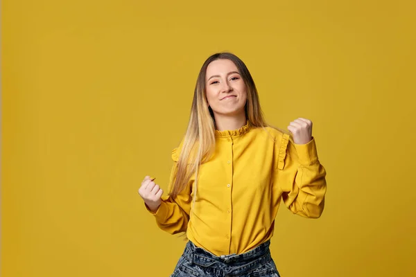 Kvinna som visar seger gest på gul bakgrund. — Stockfoto