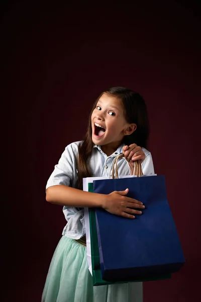 Bambina felice tiene molte borse della spesa — Foto Stock