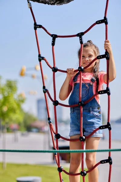 Child girl having fun on playground in sunny day — Stock Photo, Image