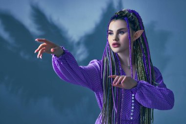 Genç ve güzel kadın elf kameraya poz veriyor.