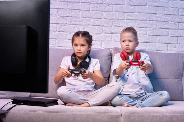 Niños jugando videojuegos con consola de juegos — Foto de Stock