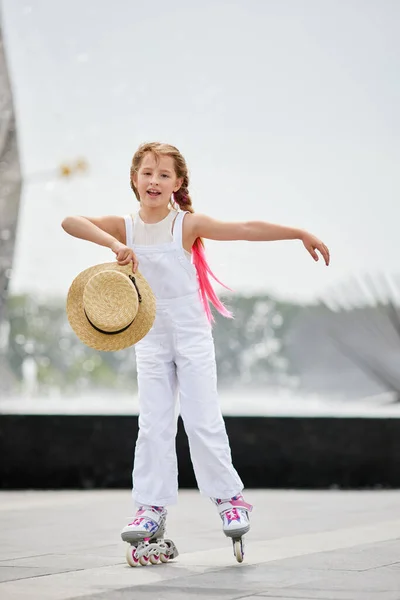 Cute little child girl on roller skates at park — Stock Photo, Image
