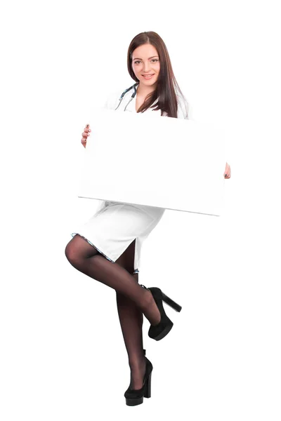 Doctor showing clipboard for text — Stockfoto