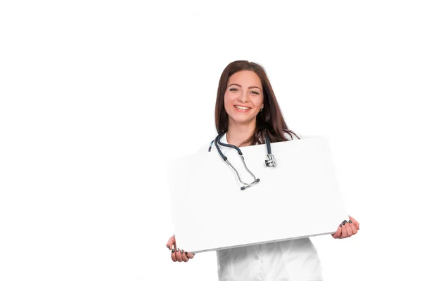 Doctor showing clipboard for text — Stockfoto