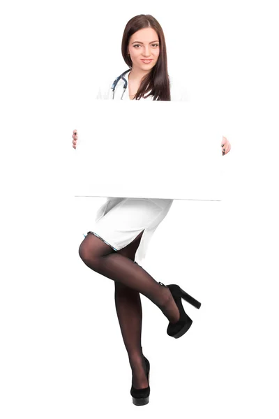 Doctor showing clipboard for text — Stockfoto