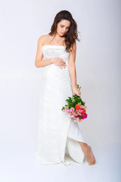 Pregnant woman and  flowers — Stock Photo, Image