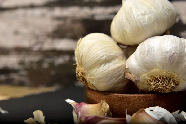 Organic white garlic on a black slate plate