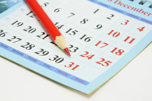Red pencil on calendar — Stock Photo, Image