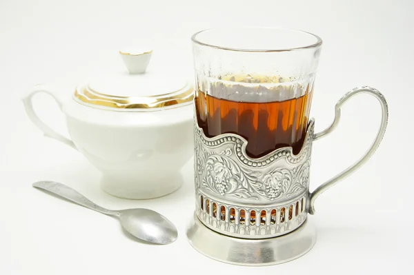 Glass of tea with sugar bowl. — Stock Photo, Image