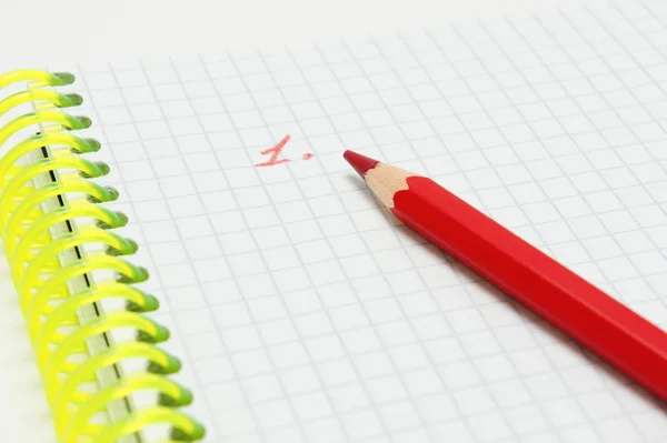 Red pencil on notebook and numeral. — Stock Photo, Image