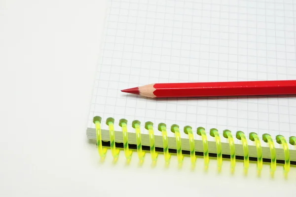 Red pen lying on a notebook. — Stock Photo, Image