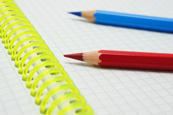 Red pencil on a background of blue pencil. — Stock Photo, Image