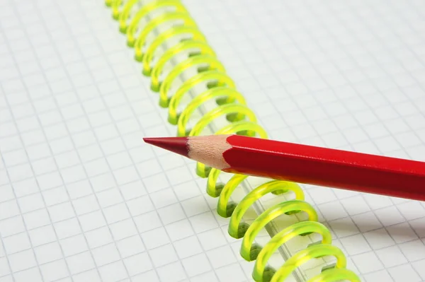 Red pen lying on a spiral. — Stock Photo, Image