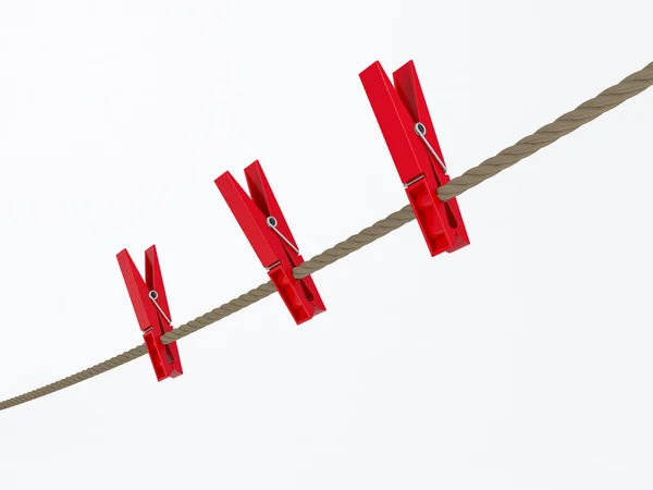 Red clothes pegs on wire — Stock Photo, Image