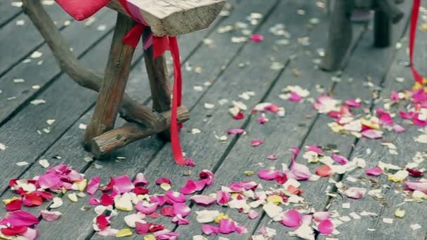 Wedding decoration, colorful petals of roses on wooden boards