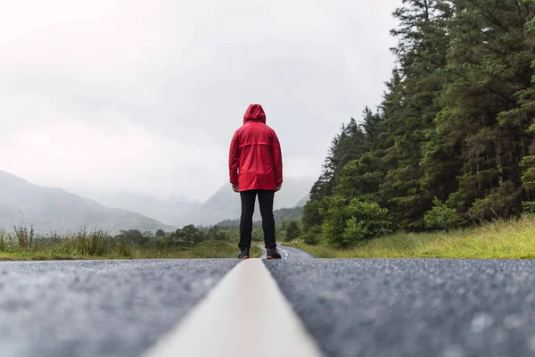 Traveler Walking Horizon Lonely Road Scotland Enjoying Scenery Wearing Red Stock Image