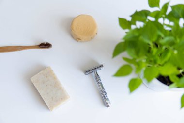 Sıfır atık ürün, başlığı kapat. Bambu diş fırçası, sağlam şampuan, metal jilet ve sağlam el sabunu. Beyaz arka planda sürdürülebilir banyo ürünleri.