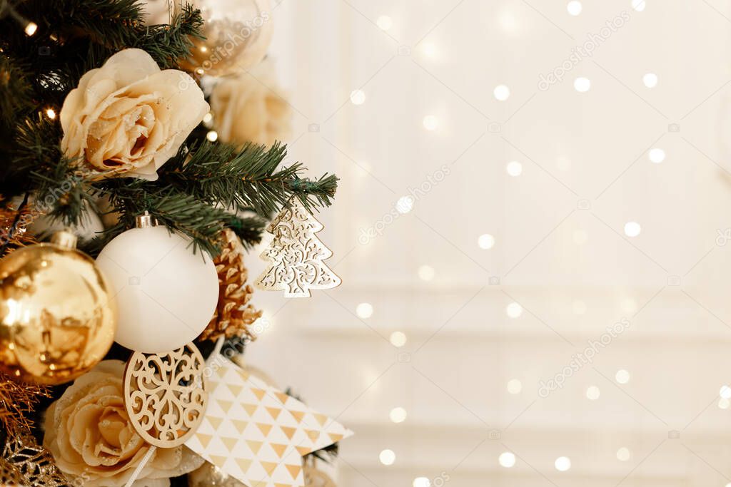 Gold Christmas background of de-focused lights with decorated tree, new year