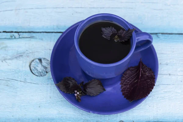 Light Blue Background Dark Blue Cup Tea Basil — Stock Photo, Image