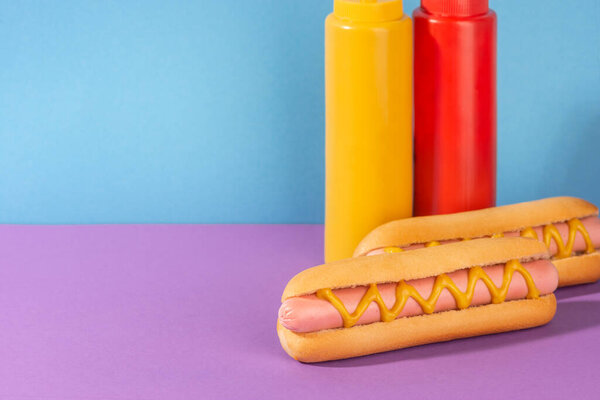 Fresh hotdogs and squeeze bottles of mustard and ketchup