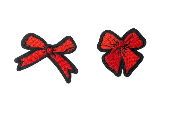 Red bow-tie embroidered badges isolated on white background — Stock Photo, Image