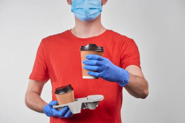 Delivery man giving a cup of coffee to a customer — Stock Photo, Image