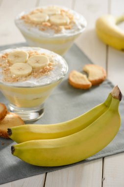 Taze muz, kurabiye ve iki porsiyon kremalı puding.