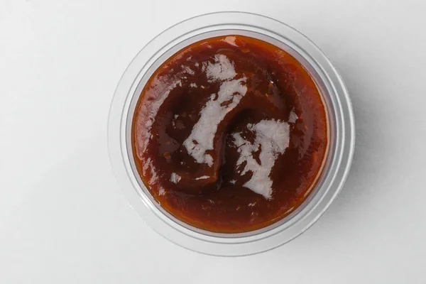 Top view on a cup of barbecue sauce on white background — Stock Photo, Image