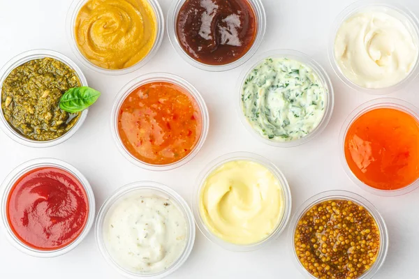Top view on variety of sauces and condiments on white background — Stock Photo, Image