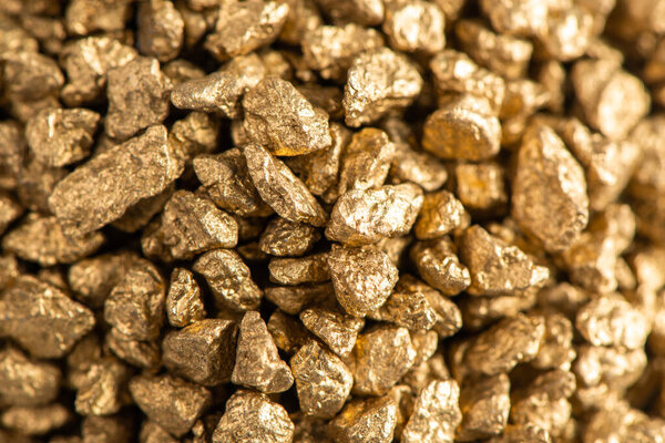 Macro view on handful of pieces of gold