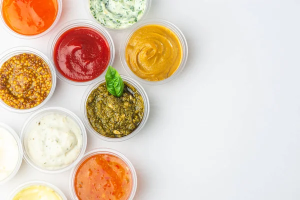 Top view on big assortment of different sauces on white background — Stock Photo, Image