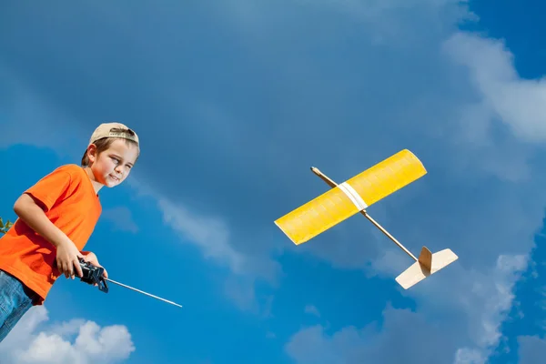 Kleine jongen spelen met handgemaakte rc vliegtuig speelgoed — Stockfoto