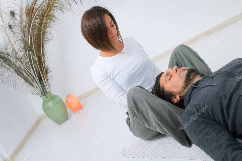 Adult man getting Shiatsu massage from Shiatsu masseuse