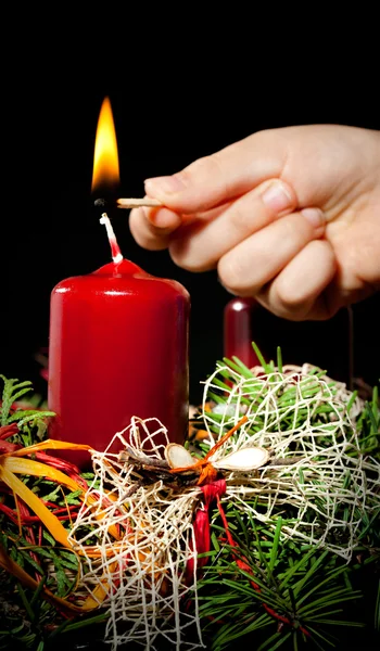 Lightning the candles on advent wreath — Stock Photo, Image