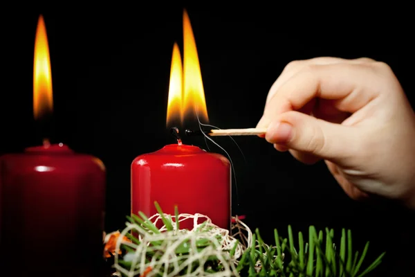 Lightning the candles on advent wreath — Stock Photo, Image