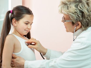 Doktor bir çocuğun bir hastanede muayene