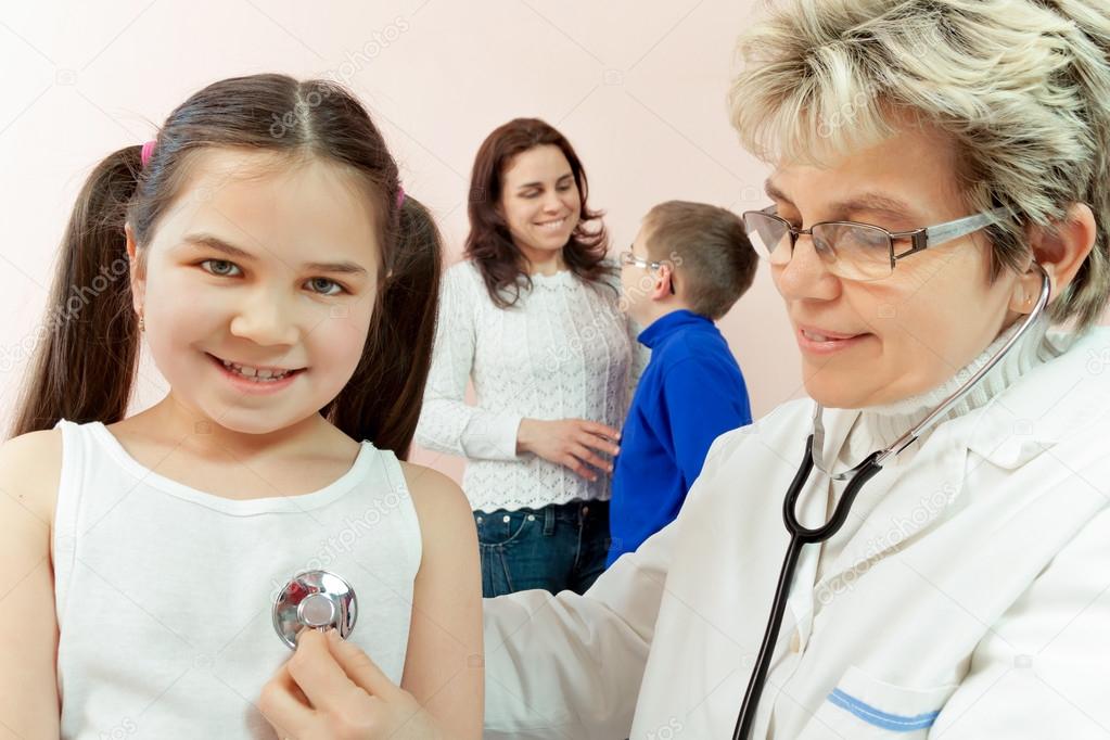 Doctor examining a child in a hospital