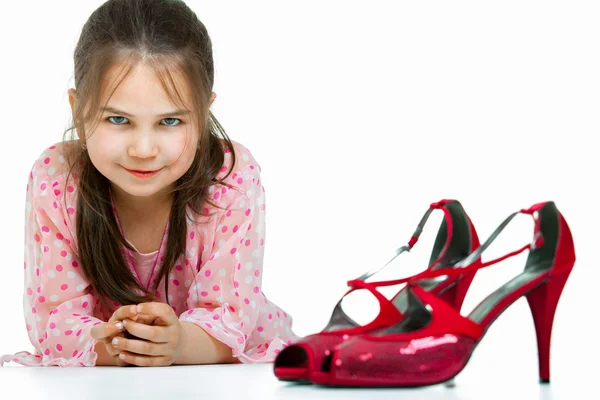 Portrait of little girl with high-heeled shoes — Stock Photo, Image