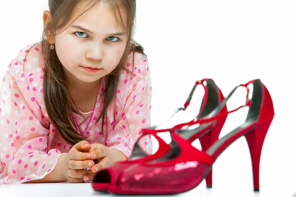 Portrait of little girl with high-heeled shoes — Stock Photo, Image