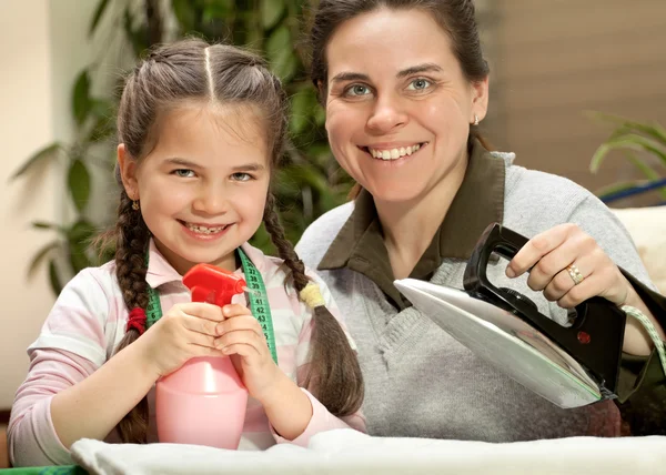 Mother ironing with little daughter — Stock Photo, Image