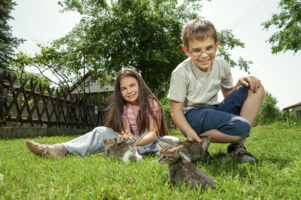 Happy children with a little cat