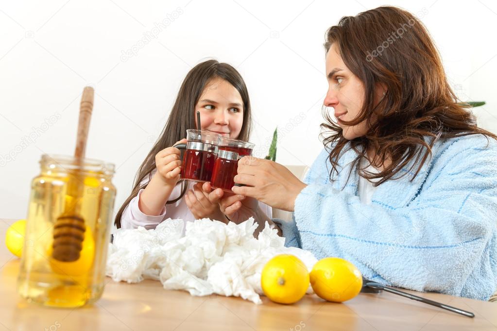 Mother and daughter with cold or flu