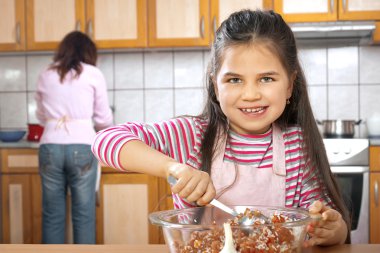 Anne ve kızı öğle yemeği için et hazırlamak