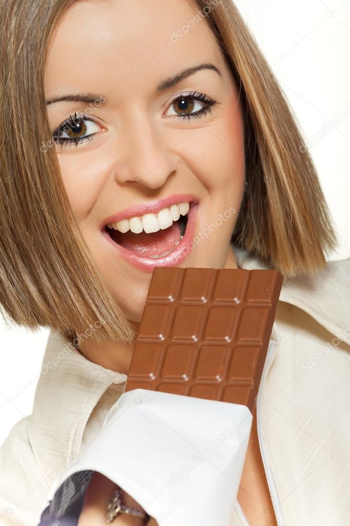 Pretty woman eating chocolate