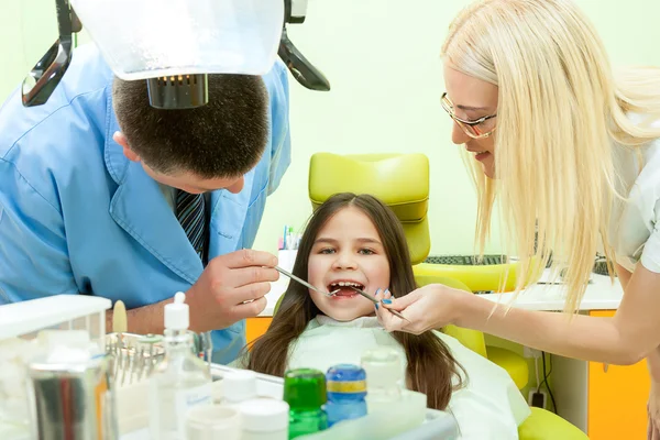 Маленька дівчинка сидить у стоматологічному кабінеті — стокове фото